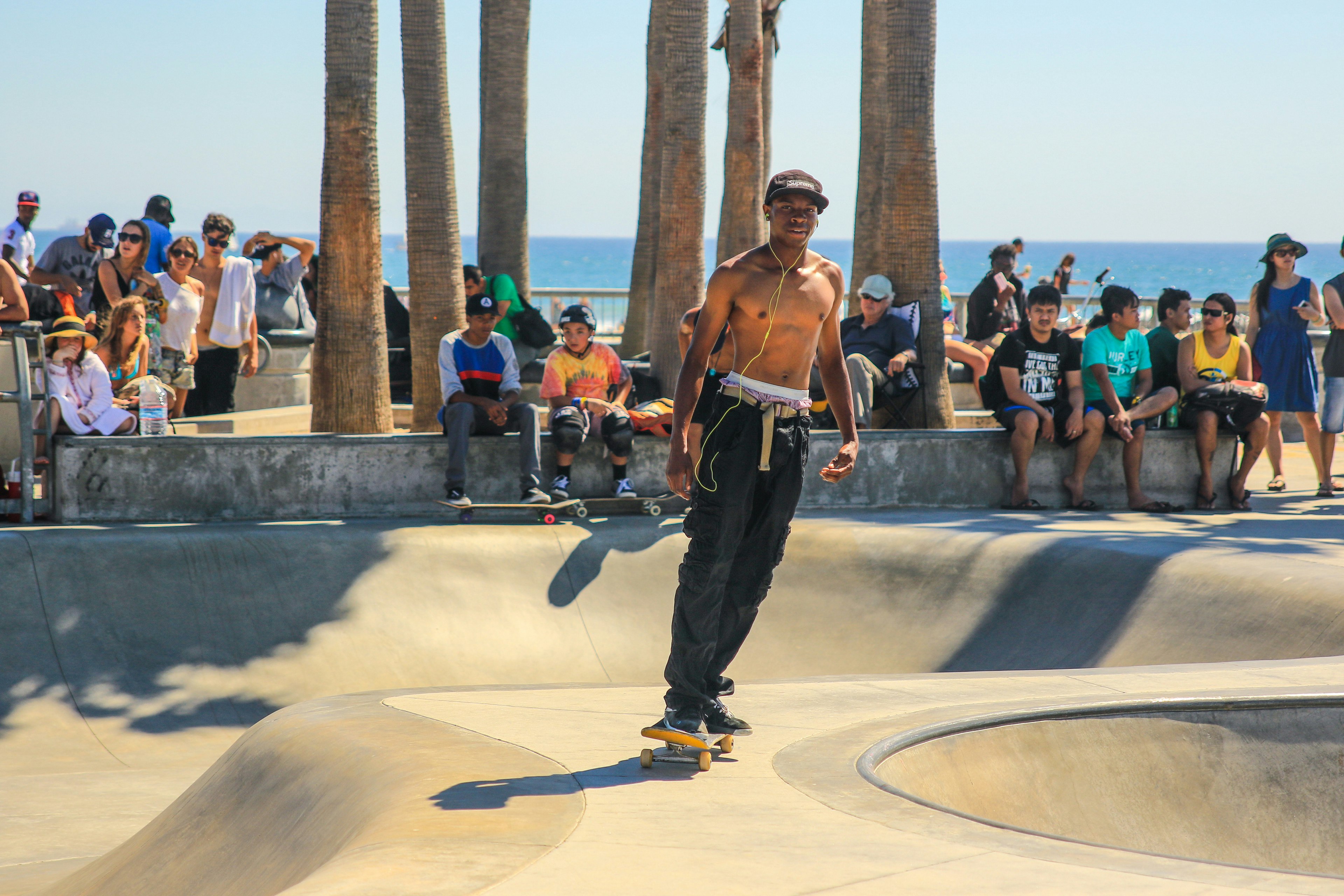 man skating in ramp surrounded with people